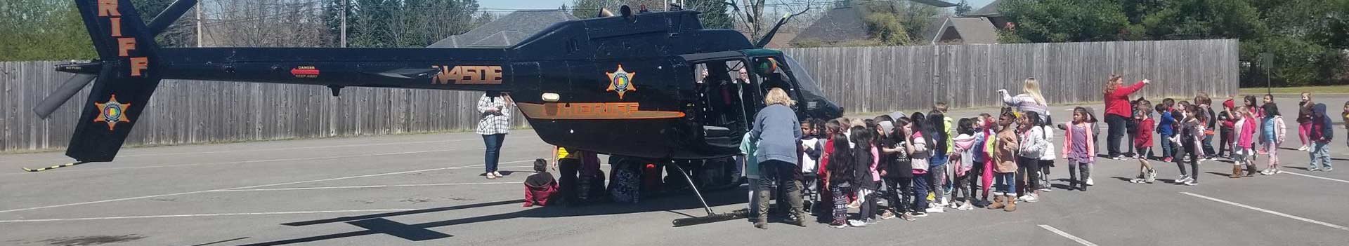 School children getting to look at the Sheriff helicopter